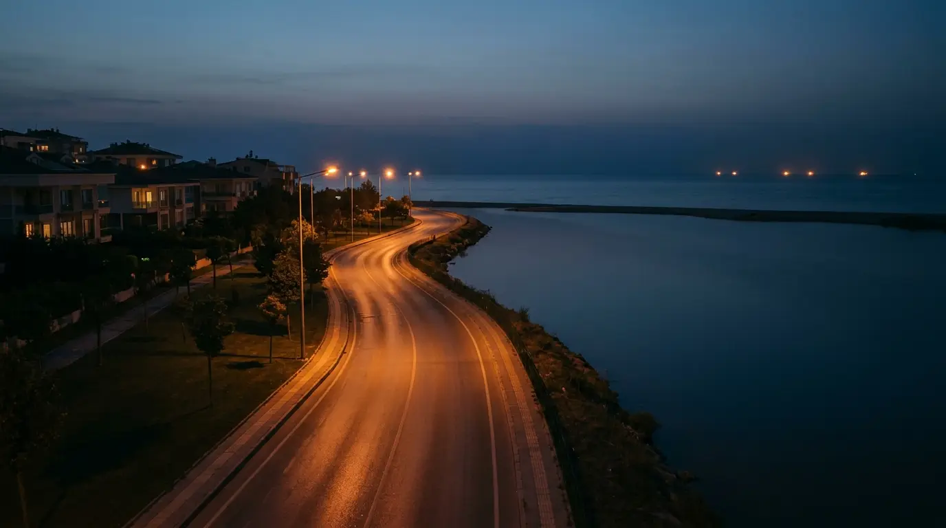 The shore road passing the lagoon at dusk.